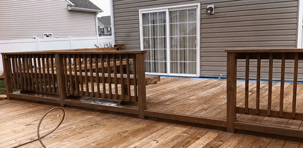 Deck sealing service protecting a backyard wood deck and railings in Norfolk, VA