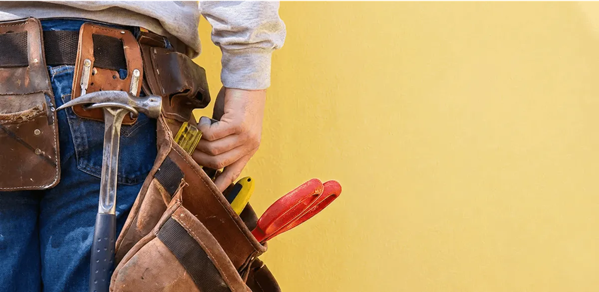 Handyman with tool belt ready for home repairs and maintenance in Norfolk, VA