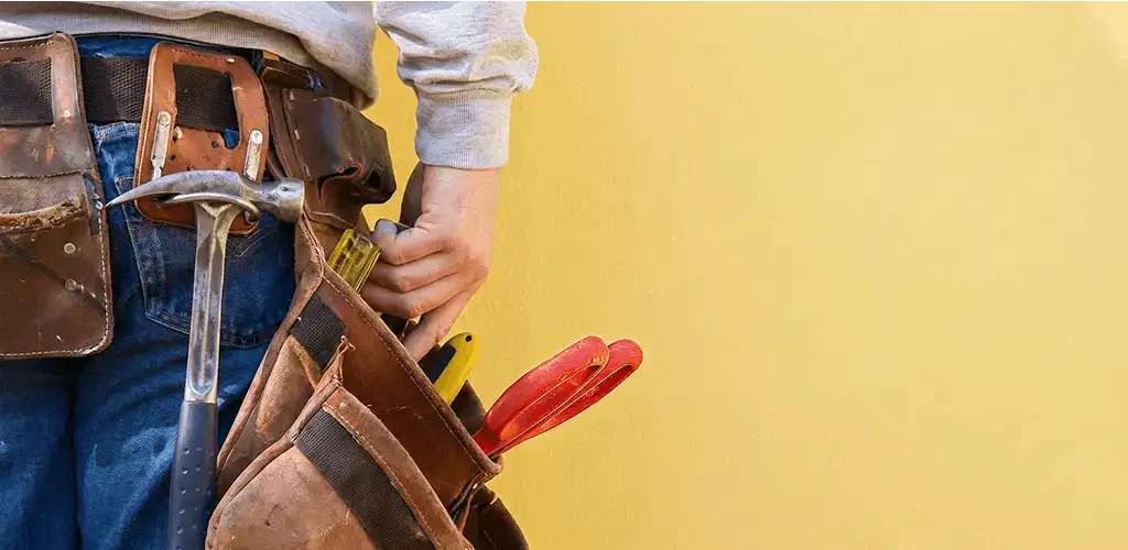 Handyman with tool belt ready for home repairs and maintenance in Norfolk, VA