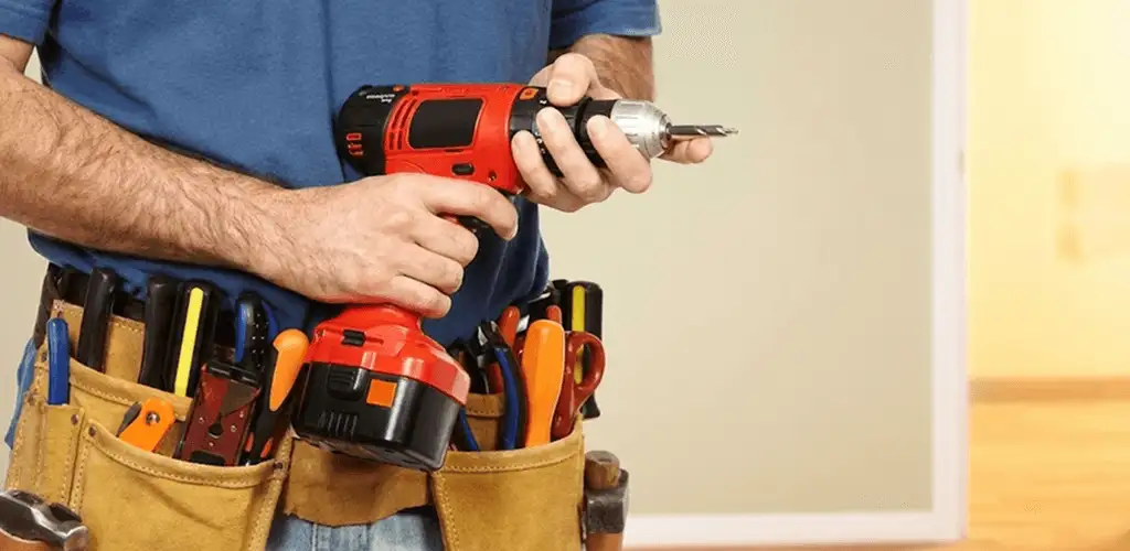 Handyman holding a power drill for home repairs and installations in Norfolk, VA