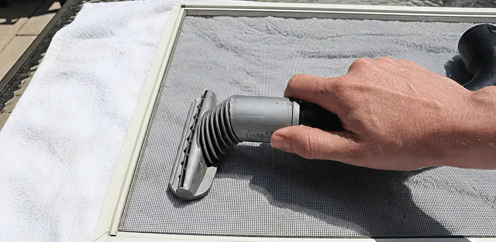 Window screen repair cleaning and fixing a damaged screen mesh in Norfolk, VA
